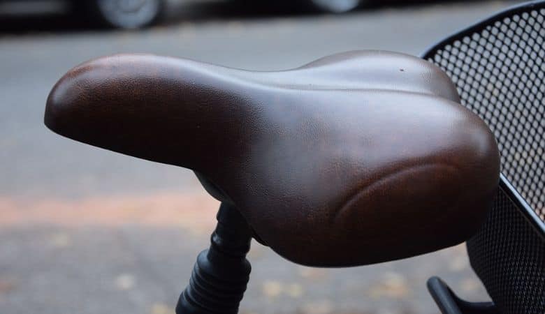 A brown wide bicycle saddle for more comfort while biking.