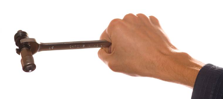 A hand holding a bicycle crack puller