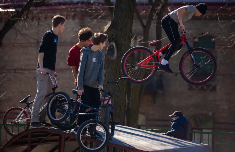Teenagers Performing Tricks On Bmx Bikes