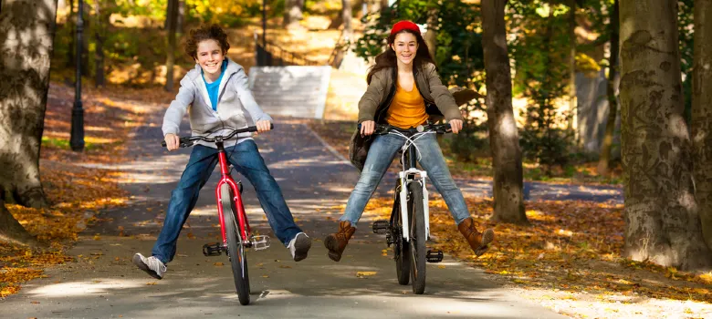 Two Teenagers Riding On Bikes