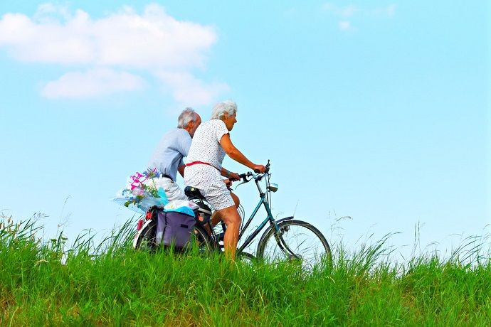 elderly couple riding further in a bicycle