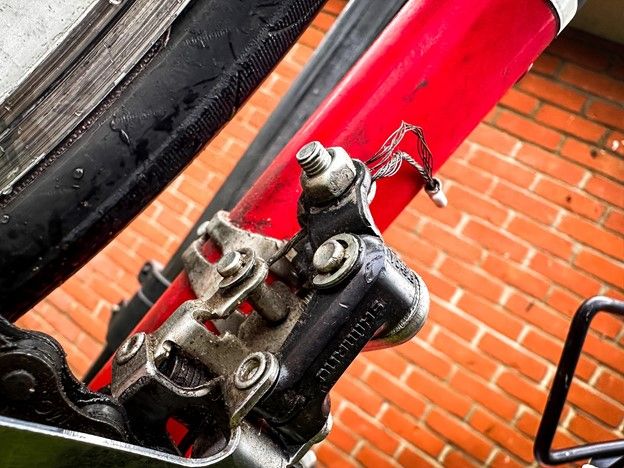 Close up shot of a greasy bike part near the pedal