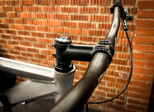 A close up image of a bike and a brick wall background
